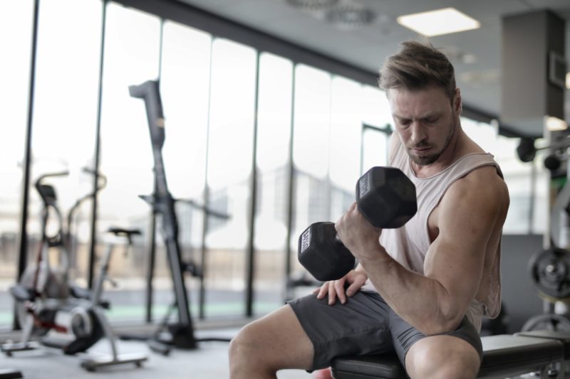 young male adult lifting weights