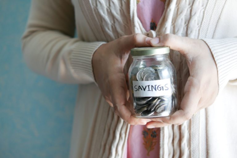 woman holding a jar with money