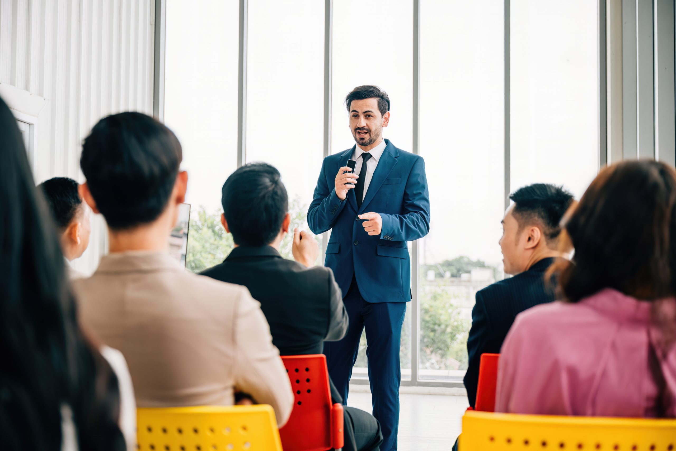 A man speaking to a room full of professionals