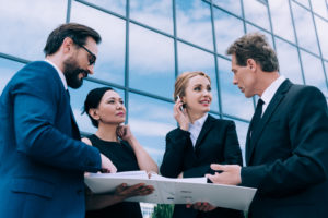 professional group of multiethnic businesspeople having discussion near modern office building