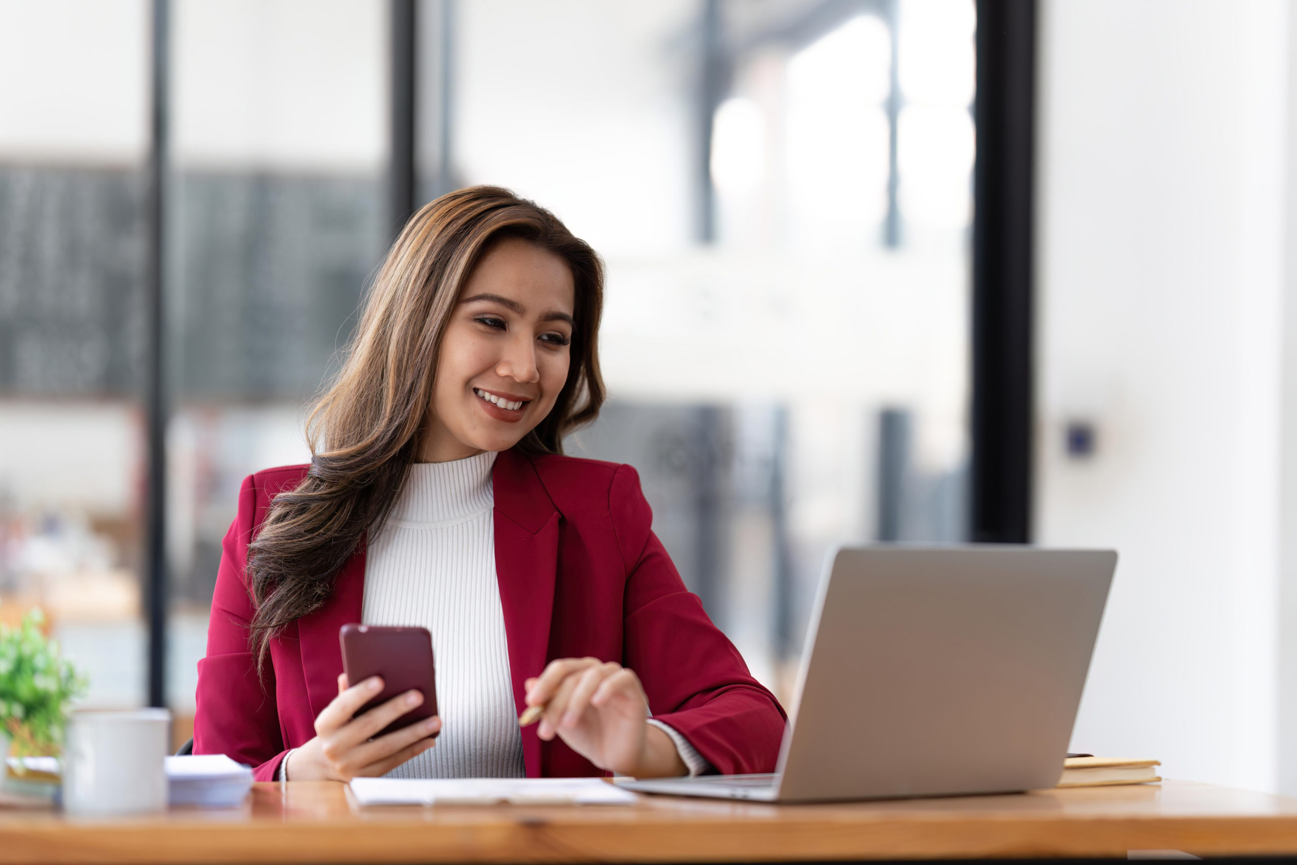 Businesswoman looking at her laptop and smiling