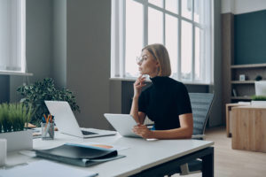 Businesswoman thinking while sitting at her desk